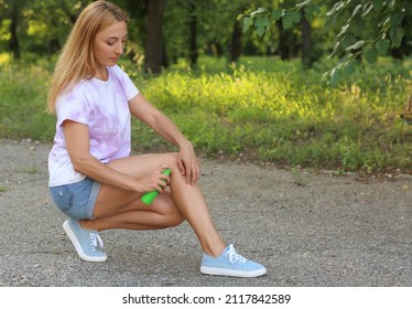 Mature Woman With Mosquito Repellent In Park