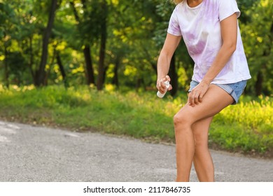 Mature Woman With Mosquito Repellent In Park