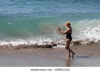 Mature Woman On The Pacific Ocean Waves