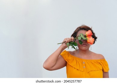 Mature Woman With Orange Flowers Outdoors