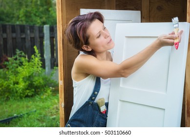 Mature Woman Is Painting With White Paint Old Furniture Outdoors