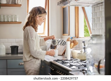 Mature woman pouring coffee in kitchen for drinking, breakfast and start relax morning at home in Australia. Happy lady enjoying mug of strong, hot and black espresso, tea and joy in apartment house - Powered by Shutterstock