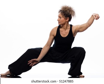 Mature Woman Praticing Tai Chi Chuan In Studio On Isolated White Background