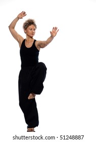 Mature Woman Praticing Tai Chi Chuan In Studio On Isolated White Background