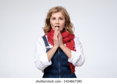 Mature Woman Pulling Being Shocked With News. Studio Shot