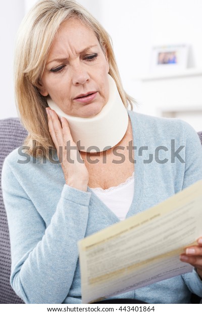 Mature\
Woman Reading Letter After Receiving Neck\
Injury