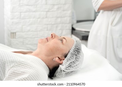 Mature Woman Receiving Facial Treatment Mask In Spa Beauty Salon. Concept Of Skin Care For Older People