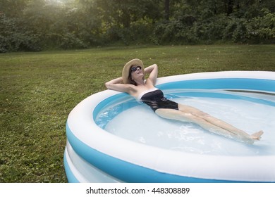 Mature Woman Relaxing In Paddling Pool