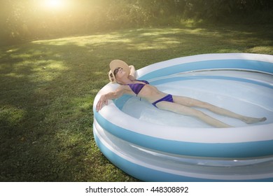 Mature Woman Relaxing In Paddling Pool