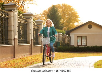 Mature Woman Riding Bicycle Outdoors. Active Lifestyle