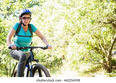 Mature Woman Riding Bike On The Wood