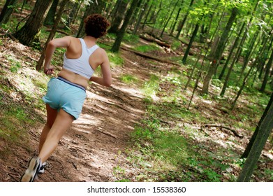 Mature Woman Running In Forest.