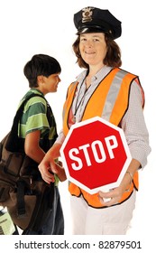 A Mature Woman School Crossing Guard Holding Out Her Stop Sign As A Student Passes Behind Her.  Isolated.