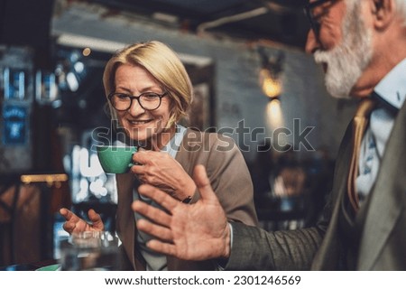 mature woman and a senior man couple engage in conversation while have cup of coffee warmth and camaraderie relish the simple pleasure of good company creating memories in setting of the cafe
