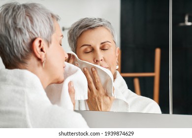 Mature Woman With Short Grey Hair Using A Towel After Washing Up Face