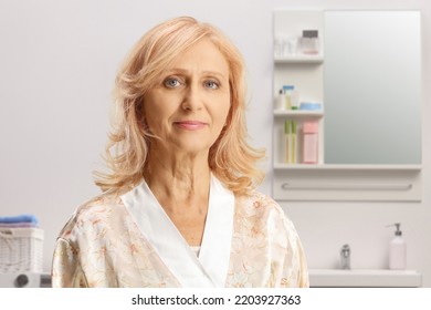 Mature Woman In A Silk Bathrobe Posing Inside A Bathroom