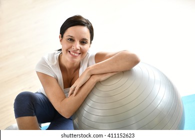 Mature Woman Sitting By Fitness Ball