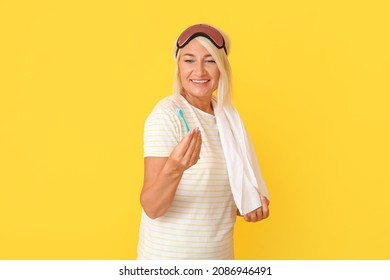 Mature Woman In Sleep Mask And With Toothbrush On Color Background