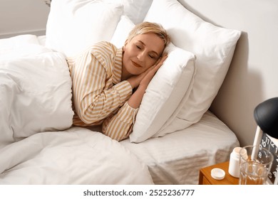 Mature woman sleeping in bed - Powered by Shutterstock