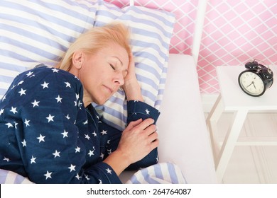 Mature Woman Sleeping In Bed