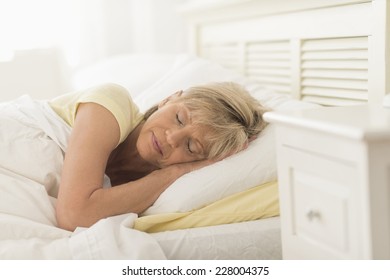 Mature Woman Sleeping In Bed At Home