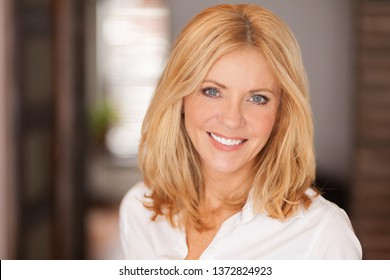 Mature woman smiling at the camera. She relaxing at home. Beautiful	 - Powered by Shutterstock