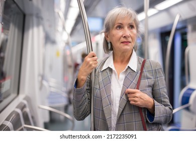 Mature Woman Standing Inside Subway Train And Waiting For Next Stop.