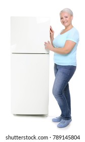 Mature Woman Standing Near Refrigerator On White Background