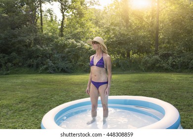 Mature Woman Standing In Paddling Pool