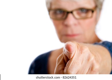 Mature woman with a stern expression pointing her finger.