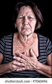 Mature Woman Suffering From Chest Pain Or Depression On A Black Background