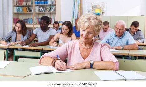 Mature Woman Take A Written Exam In The Classroom