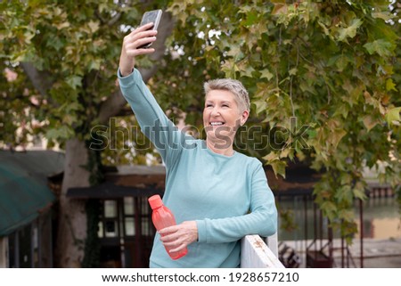 Mature woman taking a selfie during jogging