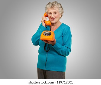 Mature Woman, Talking On Telephone On Grey Background