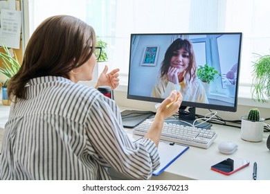 Mature woman talking online with teenage girl using video call
