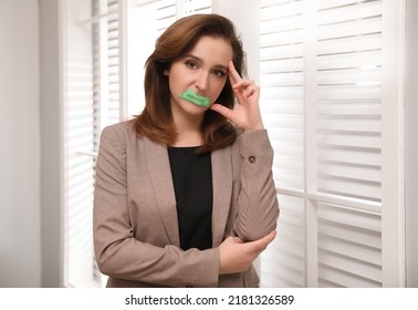 Mature Woman With Taped Mouth Indoors. Speech Censorship