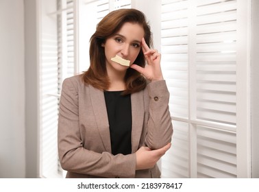 Mature Woman With Taped Mouth In Office. Speech Censorship