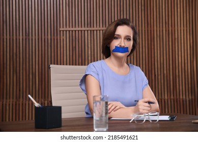 Mature Woman With Taped Mouth In Office. Speech Censorship