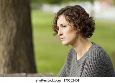 Mature Woman Thinking At The Park