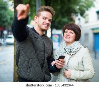 Mature Woman Tourist Asks For Directions From Man