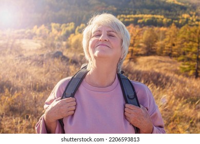 Mature Woman, Traveler Backpacking Nature Camping, Happy 60s Gray Haired Lady With Closed Eyes Breathing Fresh Air