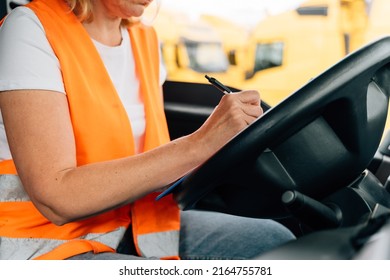 Mature Woman Truck Driver Steering Wheel Inside Lorry Cabin. Happy Middle Age Female Trucker Portrait 