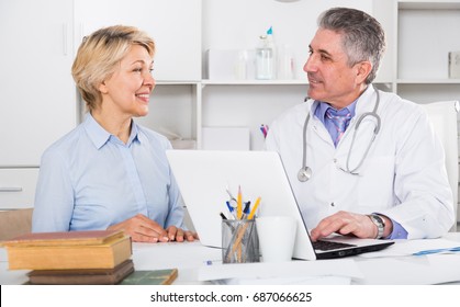 Mature Woman Visits Doctor To Medical Office For Planned Inspection Of Health