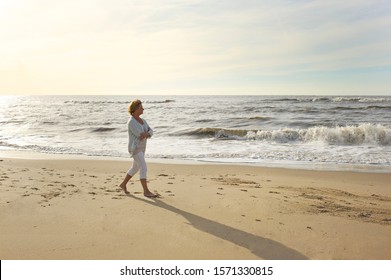 Mature Woman Walking On Beach