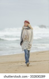 Mature Woman Walking On The Beach