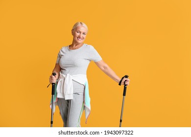 Mature woman with walking poles on color background - Powered by Shutterstock