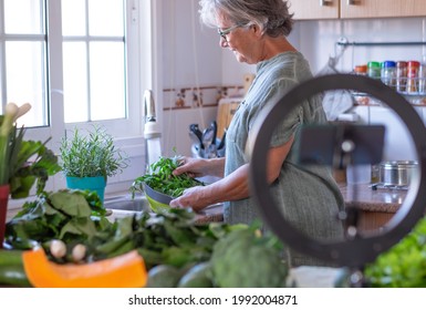 Mature Woman Washing Vegetables Recording Online Cooking Lesson, Blogger, Video - Vegetarian Vegan Diet