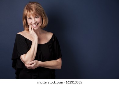 Mature Woman Wearing Black Outfit On Dark Blue Background