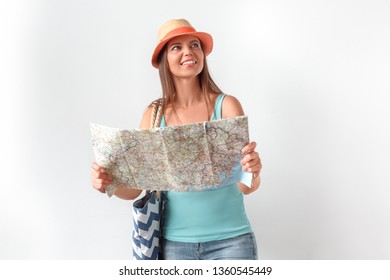 Mature Woman Wearing Hat Standing Studio Isolated On White Wall Carrying Beach Bag Holding Map Looking Aside Smiling Curious