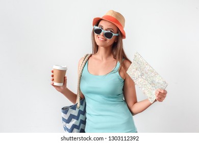 Mature Woman Wearing Hat Walking Studio Isolated On White Wall Carrying Beach Bag Holding Cup Of Hot Coffee And Map Smiling Joyful